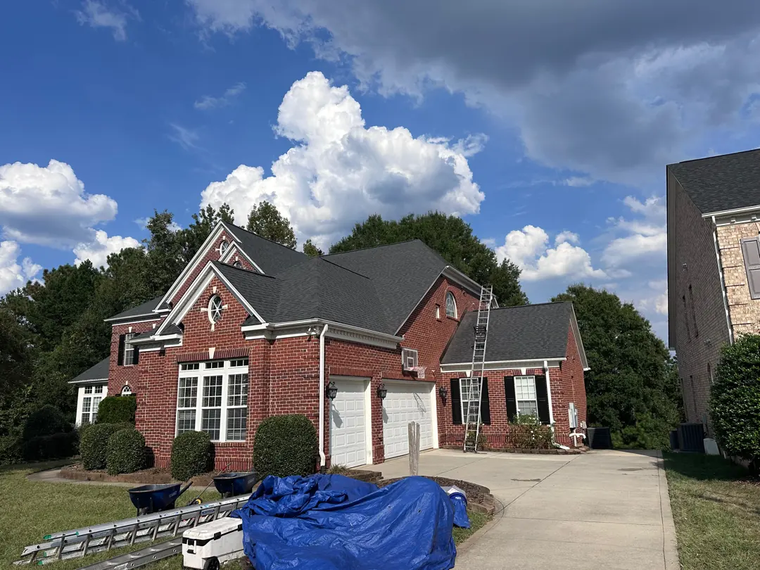 Brick home with a new charcoal roof, ladder still up